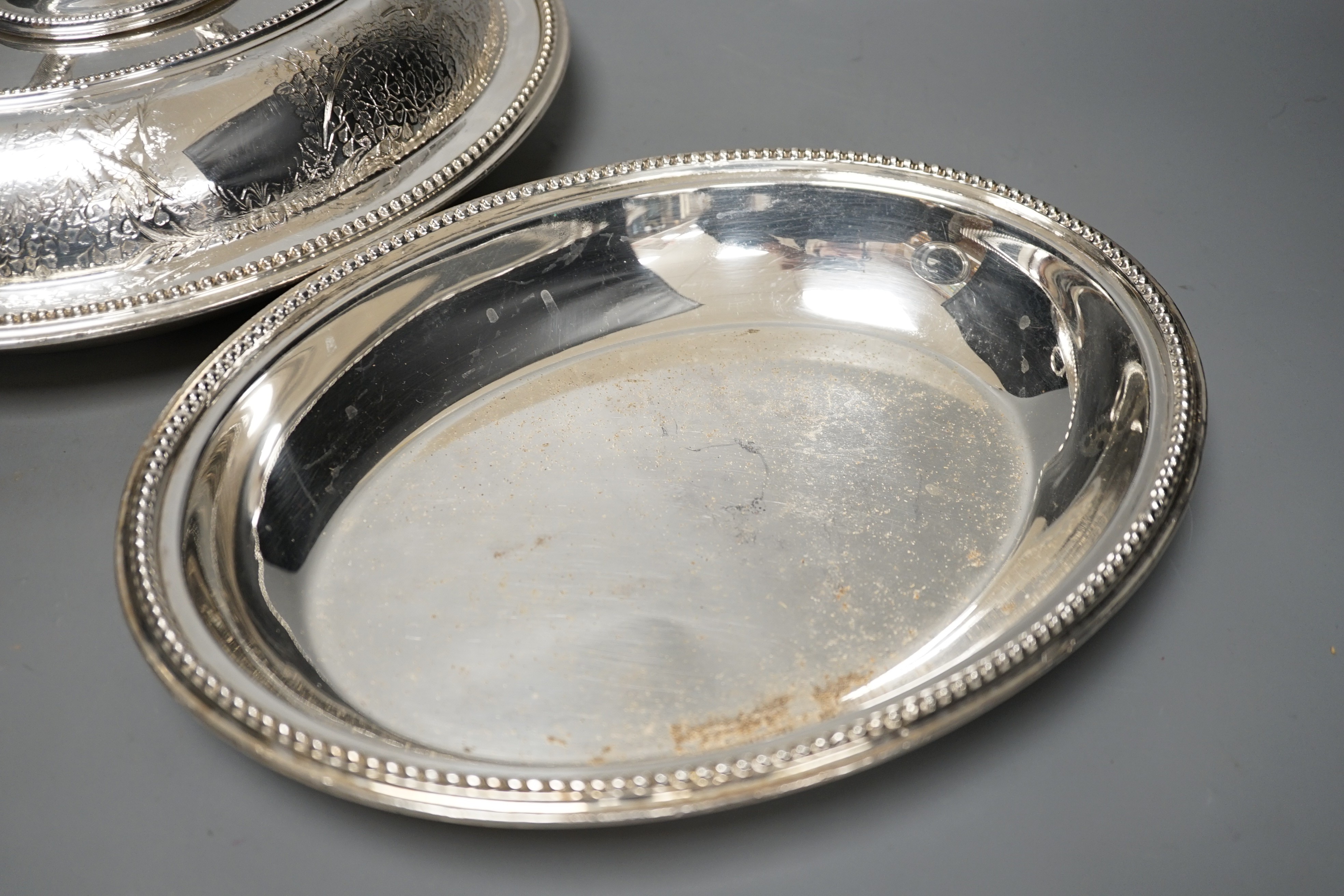 A pair of Edwardian plated engraved oval entree dishes and covers
